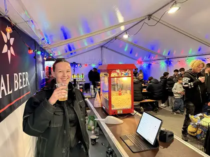 Medarbejder skåler med en gratis fadøl ved baren